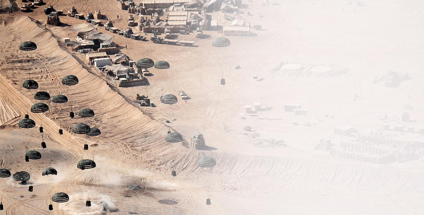 Supplies dropping from paracutes at a forward operating base in the desert